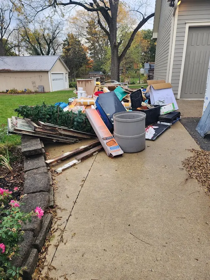 Dumpster being loaded with debris for Roofing Dumpster Rental in Burton